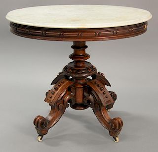 Victorian walnut oval marble top table on carved oval support and carved legs. 
ht. 32 1/4 in.; top: 37 1/4" x 28"
