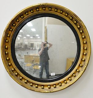 Large Federal convex mirror having parcel ebonized and gold circular form surrounded with spherical decoration. 
dia. 32 1/2 in.