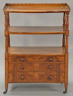 George III mahogany etagere with three shelves over three drawers all on turned legs (crack in top shelf). 
ht. 43 in.; wd. 31 1/2 i...