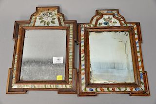 Near pair of courting mirrors, 18th century with wooden frame having reversed painted panels and a crest featuring a blossoming flow...