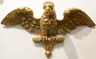 Gilt decorated wood eagle on shelf, early 19th century. 
wing span: 24 in. 

Provenance: Property from Credit Suisse's Americana Col...