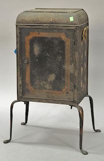 Primitive tole oven with brass handles on metal legs with pad feet. ht. 27 1/2 in.; wd. 13 1/2 in.; dp. 9 1/2 in. Provenance: Bei...