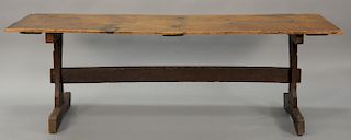 Primitive tressel foot table having pine single board top on oak tressel base. 
ht. 30 in.; top: 30 1/2" x 90"