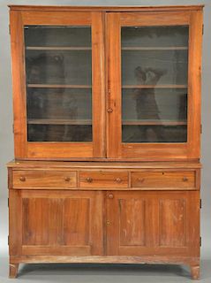 Continental walnut stepback cupboard in two parts, upper portion with two glass doors on base with three drawers over two doors on p...