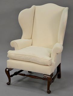 Queen Anne style upholstered wing chair on cabriole legs with pad feet with block and turned stretcher. seat wd. 34 1/2 in.
