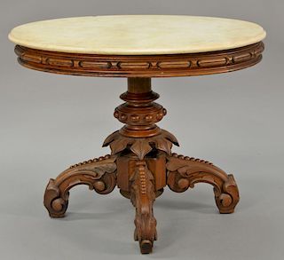 Victorian walnut oval marble top table on carved pedestal base (marble discolored). 
ht. 29 in.; top: 28" x 37"