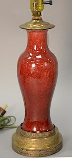 Sung de Boeuf vase made into a table lamp having copper red glaze with flambe top rim.
ht. of vase 11 in.; total ht. 24 in. 

Proven...