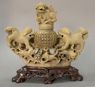 Large Chinese carved soapstone foodog sensor having foodog finial over cylindrical reticulated carved sensor surrounded by five food...