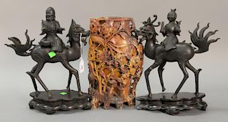 Pair of bronze foo lions sensors having Chinese figure riding on carved wood stands along with carved soapstone vase with carved pho...