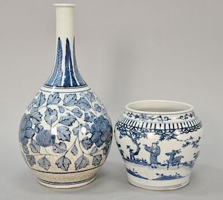 Two Oriental porcelain pieces to include a Chinese blue and white bottle vase with painted scrolling vines and flowers and a Korean ...