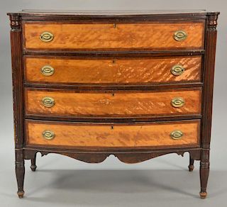 Sheraton mahogany bowed front chest of four drawers with figured maple drawer fronts all set on turned legs, circa 1830. 
ht. 40 in....