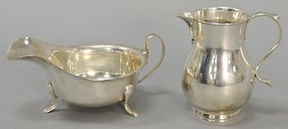 Two piece lot to include Barrard & Co. English silver creamer and an English silver small sauce boat on three legs. 
8.5 t oz.
