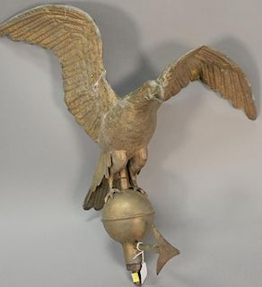 Copper eagle weathervane with wings spread, perched on ball, having some remnance of gilt under wings (as is, wings bent). 
ht. 22 1...