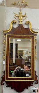 Chippendale mahogany mirror with gilt foliate urn and scrolled arch crest over drapery sides. 
ht. 50 in.; wd. 21 in.