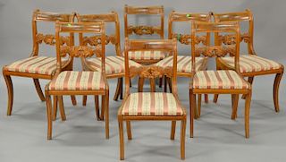 Set of eight federal mahogany side chairs having oak leaf and nut carved backs over slip seats on sabre legs, circa 1830-1840 (one c...