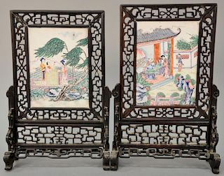 Pair of Oriental enameled on copper plaques in hardwood reticulated carved stands. 
ht. 11 1/2 in.; wd. 7 1/2 in.