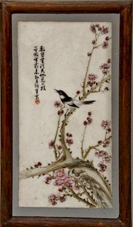Chinese porcelain framed plaque of a blossoming tree with a bird in it, signed top left.