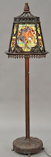 Large Tiffany style bronze floor lamp having large four sided shade with winged bird on heavy bronze base. 
ht. 77 1/2 in.