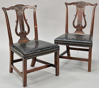Pair of George III mahogany side chairs having carved backs over upholstered seats on squared legs. 
seat ht. 18 1/4 in.