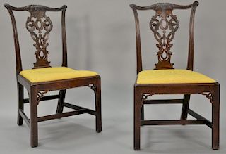 Pair of mahogany Chippendale side chairs having carved crest rails and pierce carved splats over slip seats with gardrooning between...