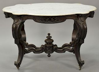 Victorian rosewood marble top center table having turtle shaped top with floral carved skirt on cabriole legs connected by X stretch...