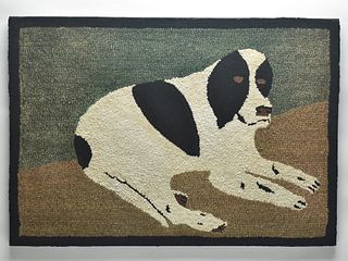 Hooked rug depicting a recumbent dog.