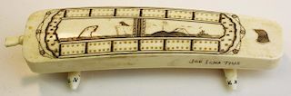 20th c Alaskan walrus tusk ivory cribbage board w// carved seals on base, signed Joe Ignatius, lengt