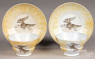 Pair of yellow spatter cups and saucers