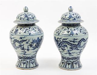 * A Pair of Blue and White Porcelain Jars and Covers Height 14 inches.