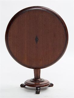 * A Diminutive Regency Style Mahogany Tilt Top Table Height 8 1/4 x diameter 10 1/4 inches.