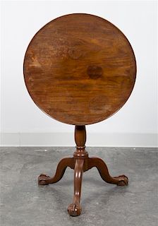 A George III Mahogany Tilt-Top Tea Table Height 26 1/2 x diameter of top 23 inches.