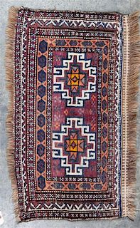 A Group of Three Rugs Largest 5 feet 10 inches x 3 feet 4 inches.