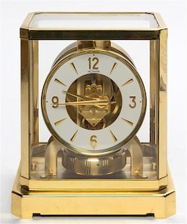 A Swiss Brass and Glass Atmos Clock, LeCoultre Height 9 1/4 x width 8 1/4 x depth 6 1/2 inches.