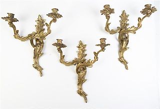 A Set of Three Louis XV Style Brass Two-Light Sconces Height 16 inches.