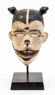 * A White-Faced Punu Mask Height overall 10 1/4 inches.