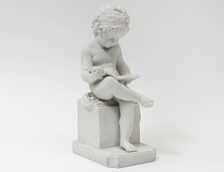 PARIAN-WARE FIGURE OF A BOY READING A BOOK