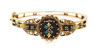 A Yellow Gold, Onyx, Seed Pearl and Turquoise Bangle Bracelet, 16.80 dwts.