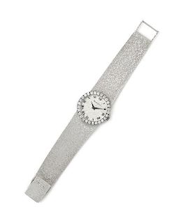 * An 18 Karat White Gold and Diamond Wristwatch, Bueche Girod, 29.30 dwts.