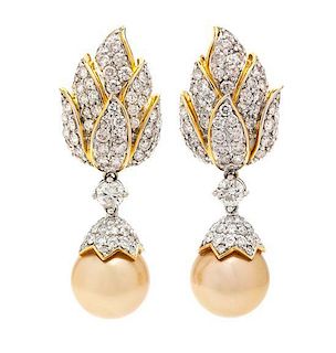 A Pair of 18 Karat Bicolor Gold, Cultured Golden South Sea Pearl and Diamond Earclips, 18.00 dwts.