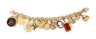 * A 14 Karat Yellow Charm Bracelet with 14 Attached Charms, 37.70 dwts