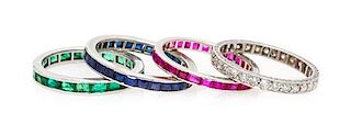 * A Collection of Platinum, White Gold, Diamond, Emerald, Ruby and Sapphire Eternity Band, 4.10 dwts.