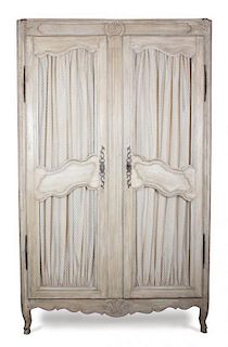A Louis XV Provincial Style Painted Armoire Height 95 1/2 x width 58 1/2 x depth 24 inches.