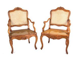A Pair of Louis XV Style Walnut Fauteuils Height 38 3/4 inches.