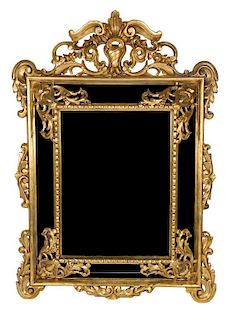 A Louis XIV Style Carved Giltwood Mirror 64 3/4 x 46 1/4 inches.
