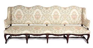 A Spanish Baroque Style Mahogany Sofa Height 43 1/2 x width 101 x depth 25 inches.
