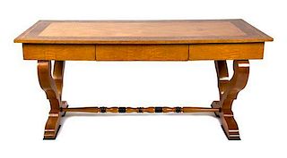 A Biedermeier Birch and Burlwood Writing Table Height 29 3/4 x width 66 x depth 29 1/2 inches.