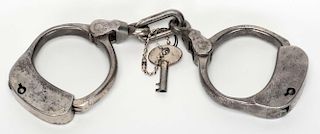 Bean Prison Handcuffs. Boston: Iver Johnson, ca. 1890s. Hallmarked, with contemporary key. Very good