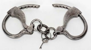 Tower Bottom Key Handcuffs. Circa late nineteenth century. Plain finish. With contemporary key. Good