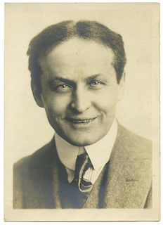 Houdini, Harry. Bust Portrait of a Smiling Houdini. Circa 1922. Famous portrait of Houdini with enig