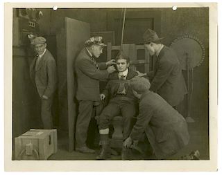 Houdini, Harry. Movie Still of Houdini in The Master Mystery. Los Angeles, [1919]. Sepia tone photo